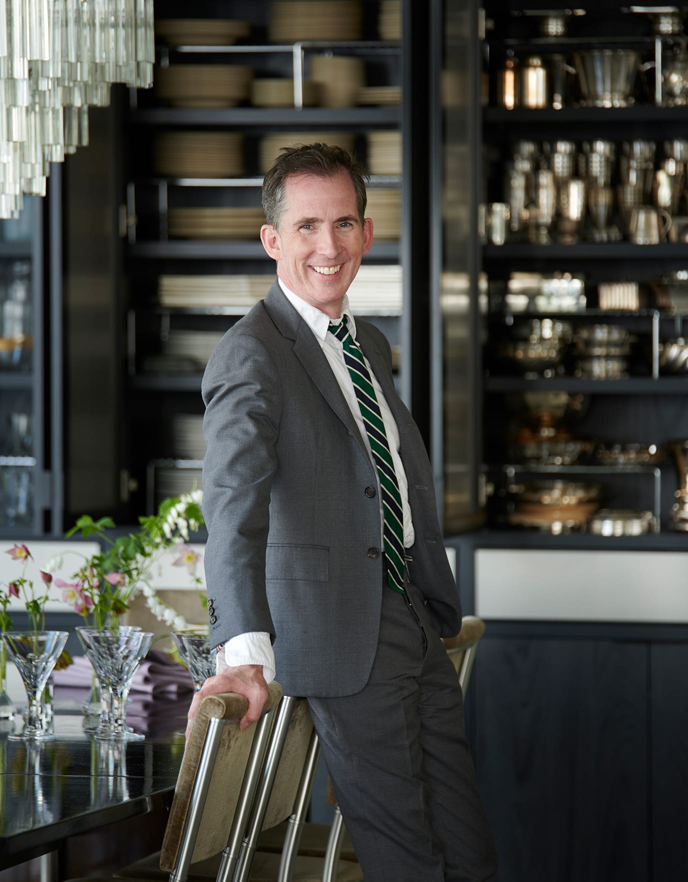 Custom dining room with built in shelving for dinner ware in dark wood finish by California Closets