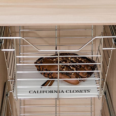 Custom garage storage wire basket storage to hold sports equipment or tools by California Closets